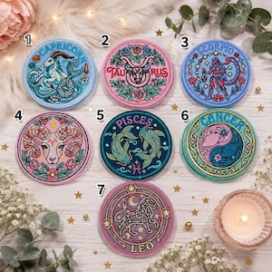 May include: Seven circular embroidered patches featuring zodiac signs labeled 1 through 7. The designs include Capricorn, Taurus, Scorpio, Aries, Pisces, Cancer, and Leo, each with intricate thread work, vibrant colors, and specific astrological symbols.
