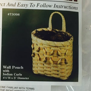 May include: A kit for making a small wall basket with Indian curls. The kit includes instructions and materials to create a 4 1/2 inch tall by 5 inch diameter basket. The kit is labeled "Mini Basket Kit" and is by Reed Creations.