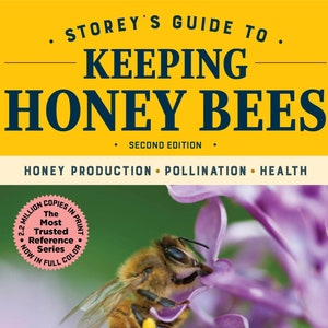 May include: A book cover with a yellow background and the title "Storey's Guide to Keeping Honey Bees" in black text. The subtitle is "Second Edition" and the book also covers "Honey Production, Pollination, Health". The cover features a close-up of a honey bee on a purple flower.