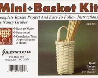 May include: A kit for making a small, white quill basket. The kit includes instructions and materials to create a basket that is approximately 5 1/2 inches tall and 3 1/2 inches in diameter. The kit is by Nancy Gruber and is part of the Reed Creations line.
