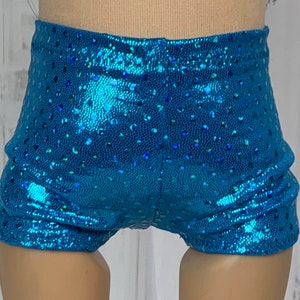 May include: Blue sparkly shorts with a dotted pattern. The shorts are made of a shiny fabric and have a high waist.