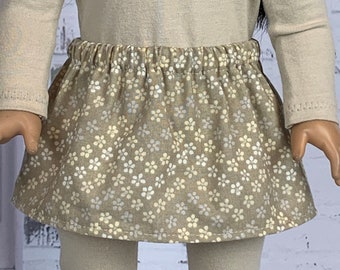 May include: A beige skirt with a floral print in shades of white and silver. The skirt has an elastic waistband and is made of a soft, comfortable fabric.