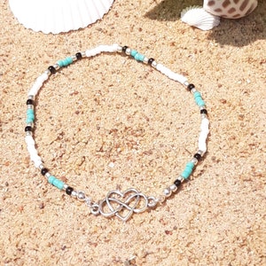 Infinity heart anklet with silver, black, turquoise, and white seed beads.