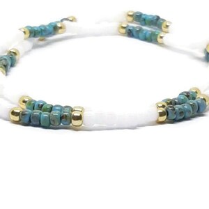 White. gold, and turquoise picasso stretchy seed bead bracelets. 2 piece set.