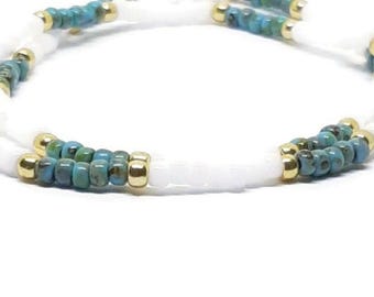 White. gold, and turquoise picasso stretchy seed bead bracelets. 2 piece set.