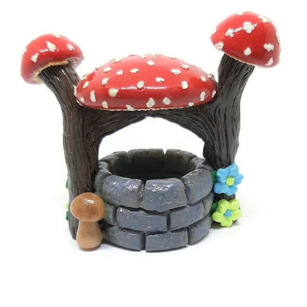 Fairy garden miniature wishing well with red mushroom top.