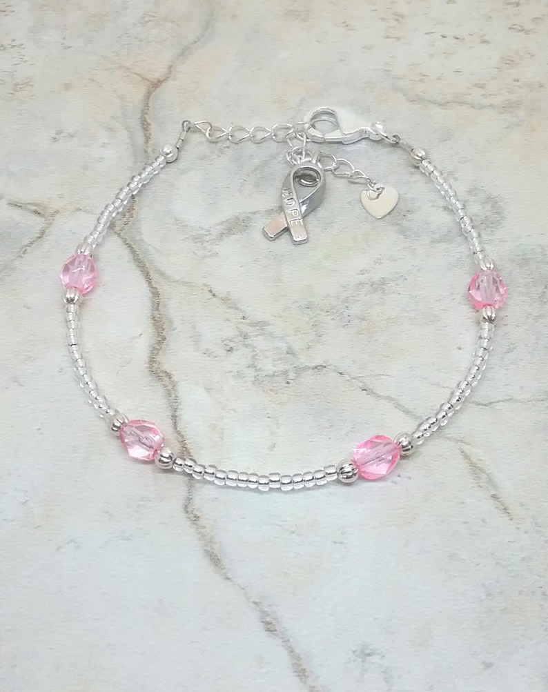 Silver-tone and pink anklet with heart and hope ribbon charm. Breast cancer awareness ankle bracelet