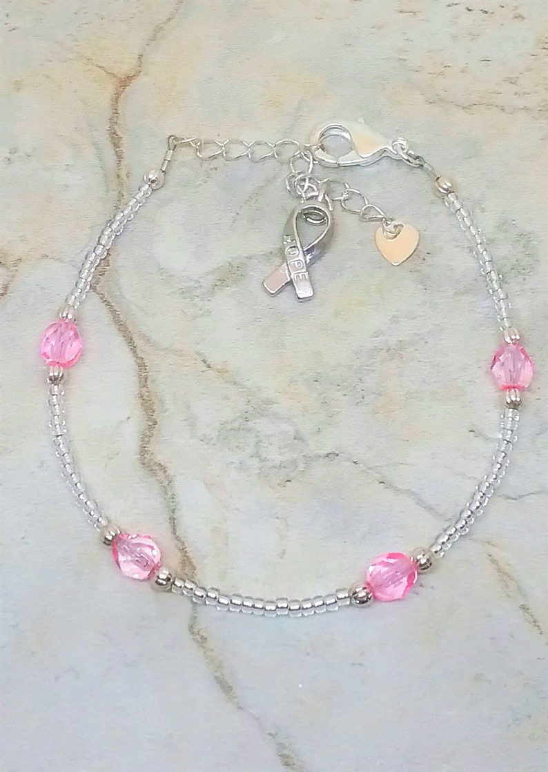 Silver-tone and pink anklet with heart and hope ribbon charm. Breast cancer awareness ankle bracelet