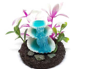 Fairy garden miniature shell waterfall. Miniature 3 tiered shell water fountain with green and pinkplants.