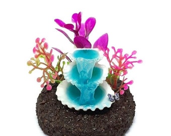 Fairy garden shell waterfall with pink and purple plants and purple butterfly. Fairy garden accessories.