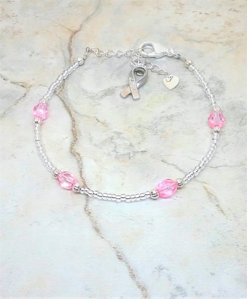 Silver-tone and pink anklet with heart and hope ribbon charm. Breast cancer awareness ankle bracelet