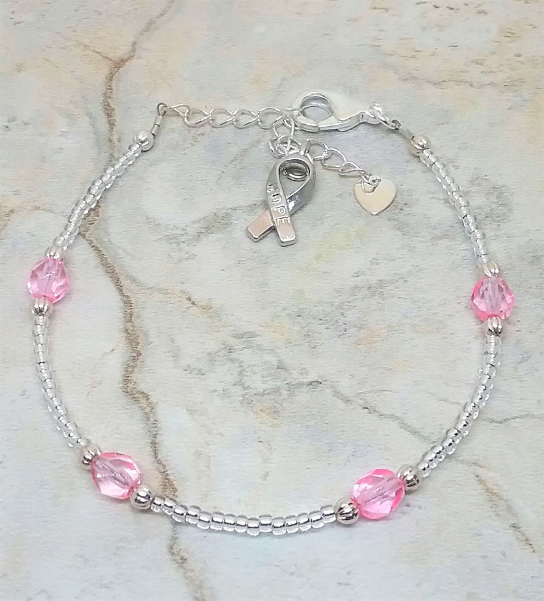 Silver-tone and pink anklet with heart and hope ribbon charm. Breast cancer awareness ankle bracelet