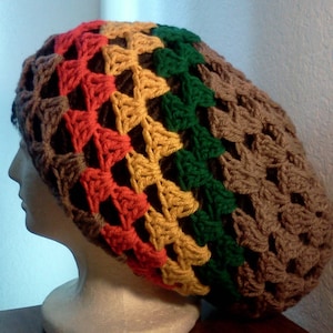 May include: A crocheted beanie hat with a brown, yellow, red, and green color pattern. The hat is made with a simple stitch and has a loose, slouchy fit.