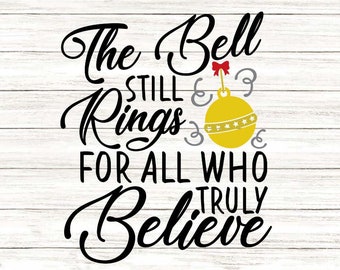 May include: A decorative sign with the text "The Bell Still Rings For All Who Truly Believe" in black script. A yellow ornament with stars and a red bow is featured. The background is a white wood grain.