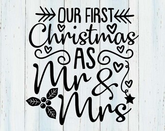 May include: Black graphic design with the text "OUR FIRST Christmas AS Mr & Mrs" on a white wooden background. The design includes arrows, hearts, and a star, with the words in a decorative font. The bottom text reads "SVG/DXF/PNG/EPS (Files delivered in black)".