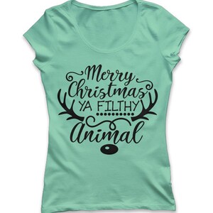 May include: A light green t-shirt with a scoop neck. The shirt features the text "Merry Christmas Ya Filthy Animal" in black script, with reindeer antlers and a small dot design. The word "Animal" is in a larger font.
