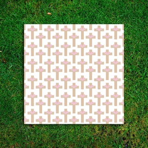 May include: A seamless pattern featuring a repeating design of brown crosses with pink floral wreaths on a white background.