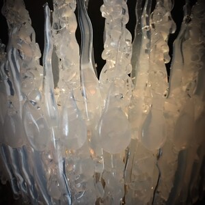 Close-up of the clear transparent Jewelled Ice Queen Crown. A sculptured real ice-like icicle crown with ice like ‘jewels’. Glass like sculpture Ice Crown which has a delicate, organic appearance.