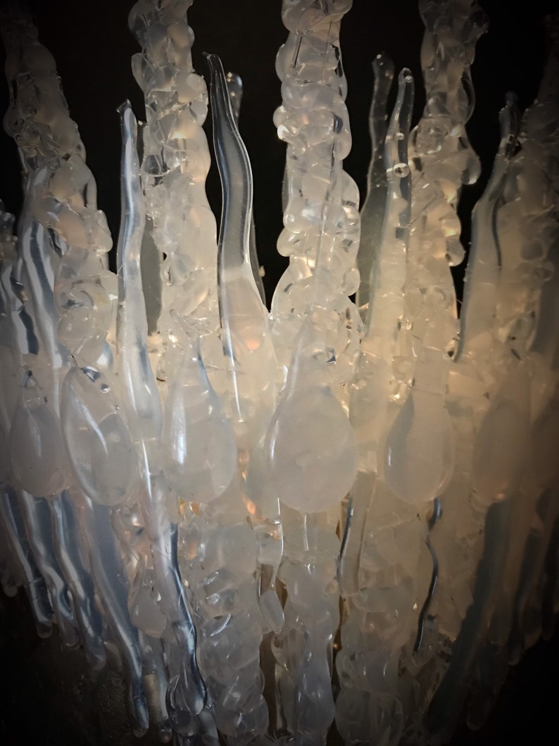 Close-up of the clear transparent Jewelled Ice Queen Crown. A sculptured real ice-like icicle crown with ice like ‘jewels’. Glass like sculpture Ice Crown which has a delicate, organic appearance.