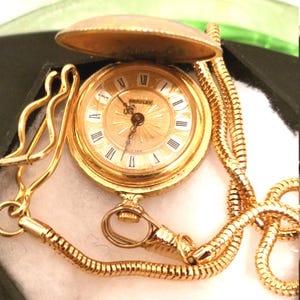 Bradley Swiss made Gold face, Brass small wind-up Pocket watch, fob and chain, floral design on watch case, vintage
