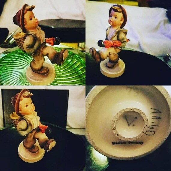 hummel boy walking with umbrella