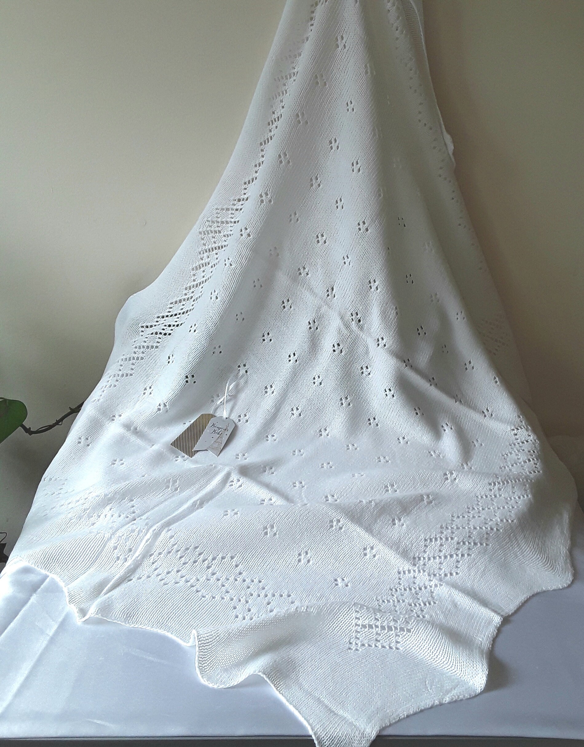A Beautiful White Lacey Baby Shawl made with Acrylic.