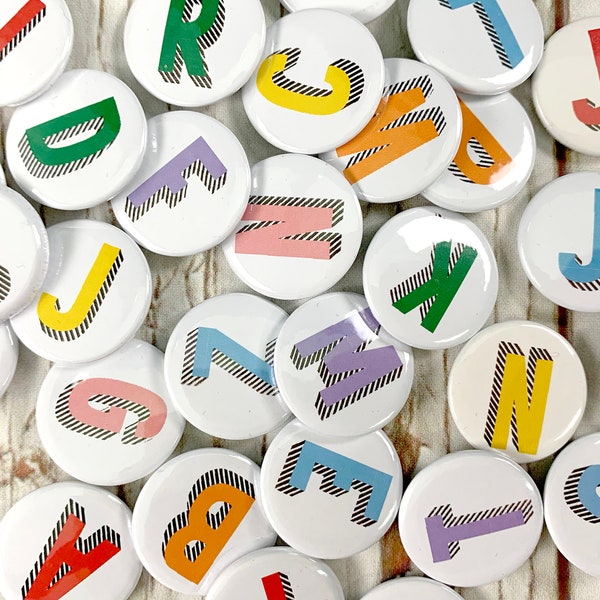 Alphabet pin badges. Word lover. Letter Button rainbow of colours. ''Bradford Buzz' font. Small 25mm, Large 38mm Name initial A-Z