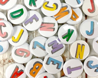 Alphabet pin badges. Word lover. Letter Button rainbow of colours. ''Bradford Buzz' font. Small 25mm, Large 38mm Name initial A-Z