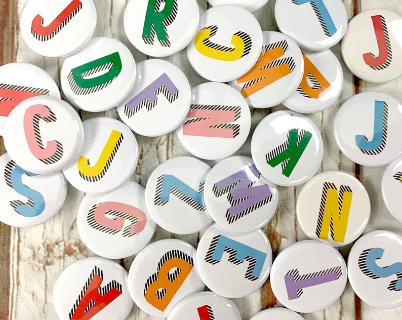 Alphabet pin badges. Word lover. Letter Button rainbow of colours. ''Bradford Buzz' font. Small 25mm, Large 38mm Name initial A-Z image 1