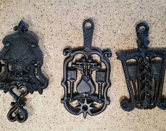 5 Vtg. Cast Iron Trivet Collection