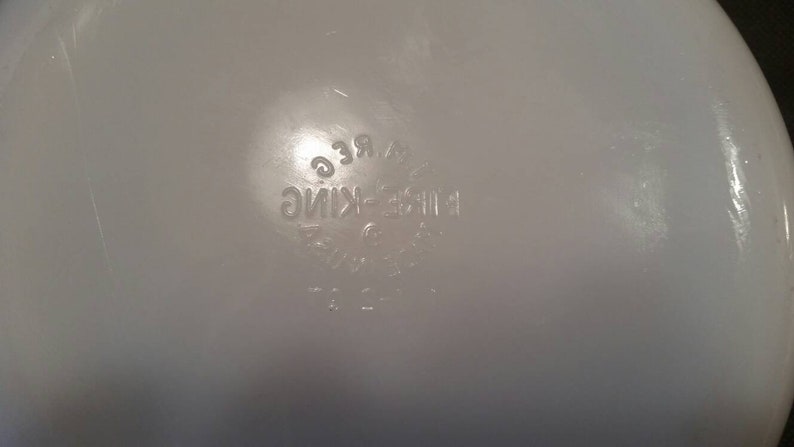 K&ouml;nnte beinhalten: Wei&szlig;e Keramiksch&uuml;ssel mit der Aufschrift "Fire-King Ware" auf dem Boden.