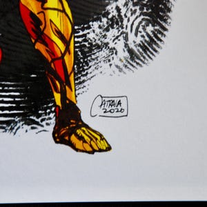 May include: Illustration of a leg and foot in shades of yellow, orange, and red, with black accents. The artwork is signed "ATRAIA 2020" in a small rectangle. The style appears to be comic book or graphic novel art.