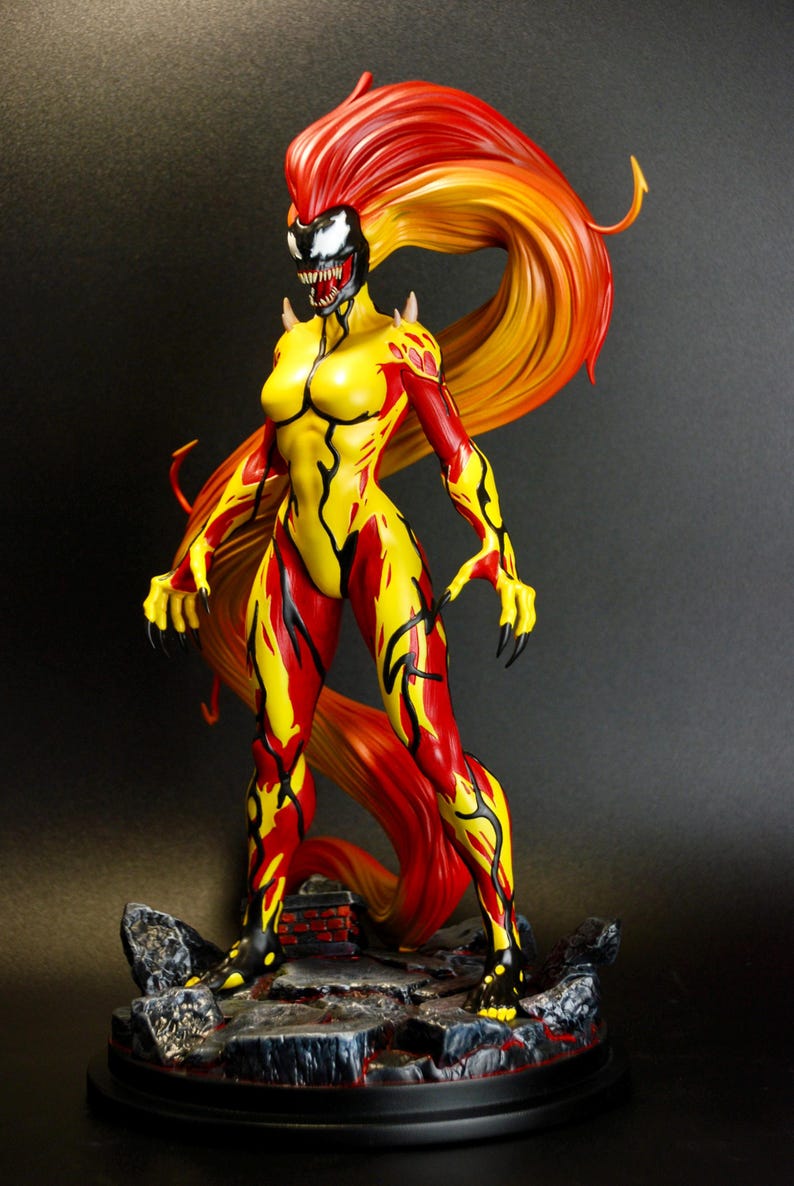 May include: A detailed figurine of a female character with a fiery appearance. The figure is predominantly yellow and red, with a flowing hairstyle that transitions from red to yellow. The character has sharp claws and stands on a rocky base.