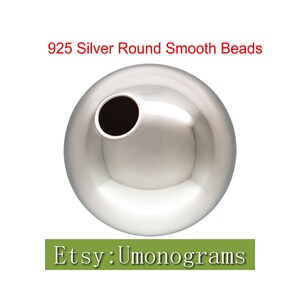 May include: A silver round bead with a smooth surface. The bead is 925 silver and is perfect for jewelry making.