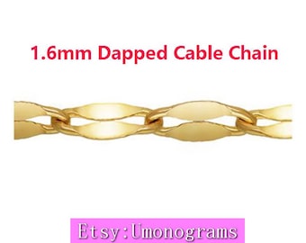 May include: A close-up of a 1.6mm gold-toned dapped cable chain. The chain is made of small, oval-shaped links that are interlocked.