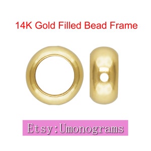 May include: Two 14K gold filled bead frames. Each frame is a round ring with a hole in the center. The frames are shown side-by-side.