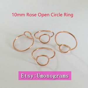 May include: Four rose gold open circle rings. The rings are 10mm in diameter and have a simple, minimalist design. Etsy: Umonograms