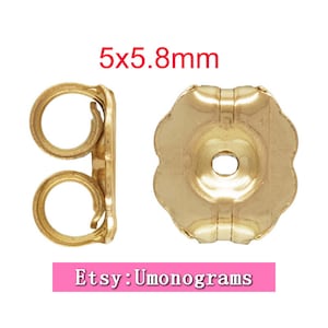 Op de afbeelding: Gouden oorbelruggen, 5,8 mm in diameter, met een glad, afgerond oppervlak en een klein gaatje in het midden. De ruggen zijn ontworpen om oorbellen op hun plaats te houden.