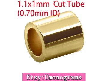 May include: Gold-colored metal tube with a 1.1 mm x 1.1 mm outer diameter and a 0.70 mm inner diameter. The tube is cut and has a smooth, shiny finish. The text "1.1x1mm Cut Tube (0.70mm ID)" is visible above the tube. The text "Etsy: Umonograms" is visible below the tube.