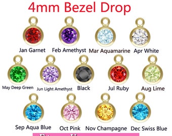 May include: Twelve 4mm bezel drop charms with different colored gemstones. The charms are arranged in four rows of three. The gemstones are garnet, amethyst, aquamarine, white, deep green, light amethyst, black, ruby, lime, aqua blue, pink, and champagne.