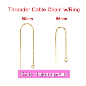 May include: Two gold cable chain threader earrings with a ring at the end. The earring on the left is 80mm long and the earring on the right is 65mm long. Etsy: Umonograms