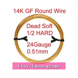 May include: A spool of 14K gold filled round wire, 24 gauge, 0.51 mm in diameter. The wire is labelled "Dead Soft 1/2 HARD".