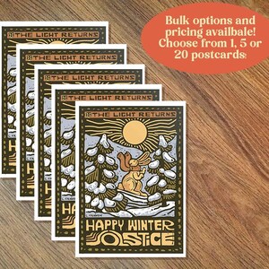 May include: A stack of five postcards featuring a woodblock style illustration of a rabbit in a snowy forest with the text "The Light Returns" and "Happy Winter Solstice".