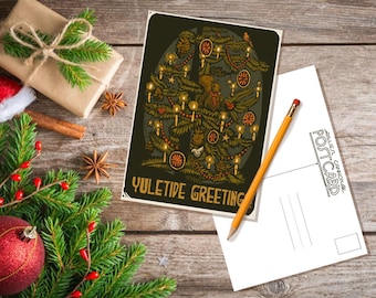 May include: A vintage-style postcard featuring a stylized illustration of a Christmas tree with ornaments, candles, and a bird. The text "Yuletide Greeting" is printed at the bottom of the postcard.