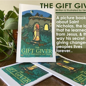 May include: Three copies of a children's book titled "The Gift Giver" by Liesl Cannon. The book cover features a green and brown illustration of a person walking up a path to a building with a lit window. The text on the cover reads "The Gift Giver" and "Written & Illustrated by Liesl Cannon".