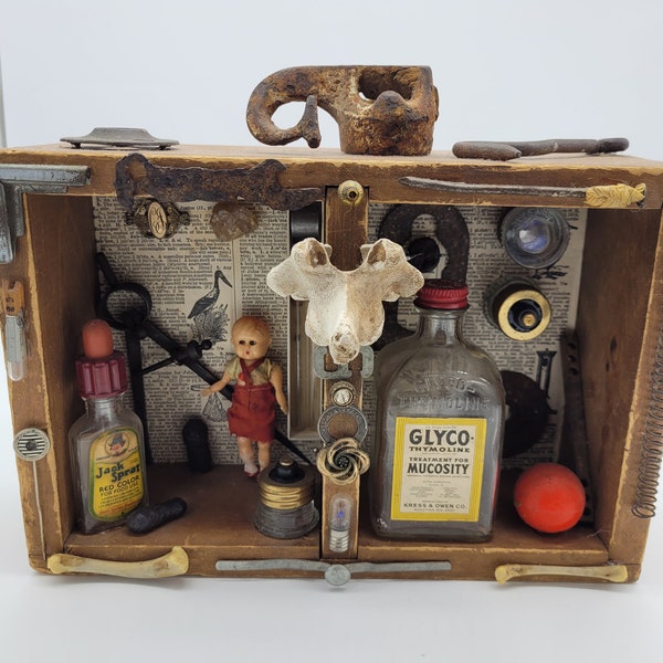 Assemblage art, antiques, animal bones, dolls, rusty metal, vintage antique medical bottles, vintage Japanese doll