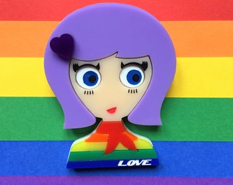 LOLA Acrylic Brooch, rainbow flag sweater and purple hair.