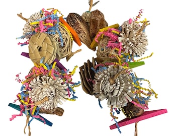May include: A colorful bird toy with a variety of textures and materials, including woven straw, wood, and paper. The toy is designed to provide enrichment and entertainment for birds.