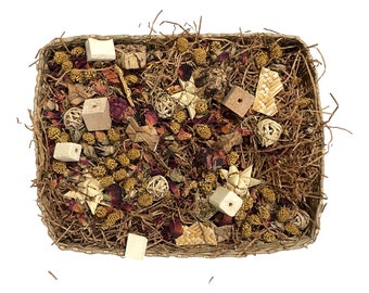 May include: A woven basket filled with natural materials, including dried flowers, wood, and straw. The basket is a light brown color and the materials inside are a variety of colors, including beige, brown, and pink.