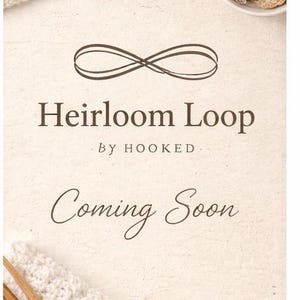 May include: Cream-colored crochet fabric with wooden knitting needles and a small bowl of natural elements. The text "Heirloom Loop By Hooked Coming Soon" is displayed in a soft, elegant font, suggesting a craft-related theme.
